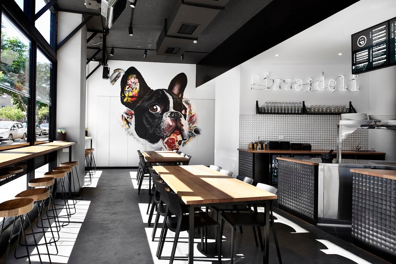 Inside Pizza:deli — French Bulldog mural & neon signs