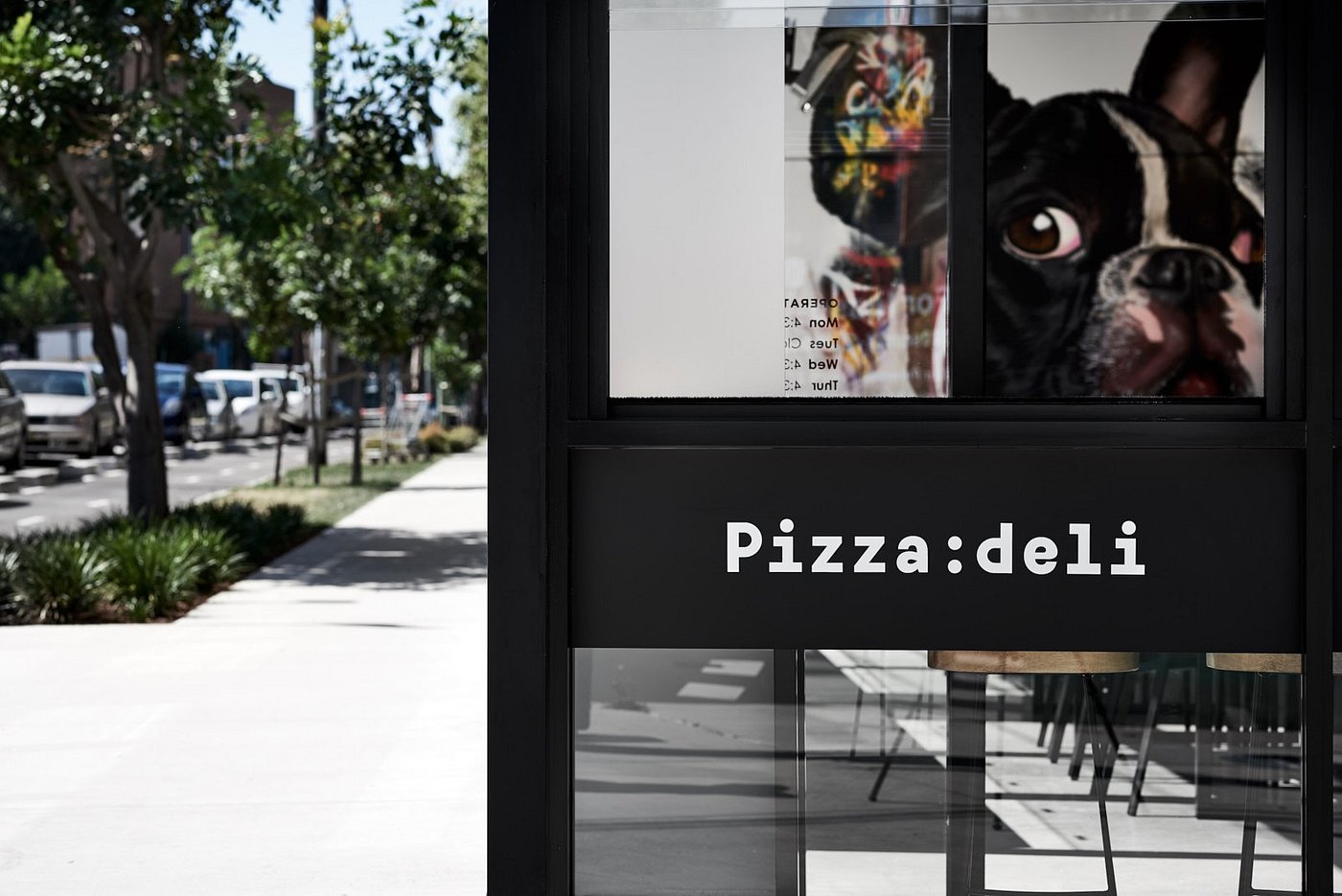 Pizza:deli window signage from street