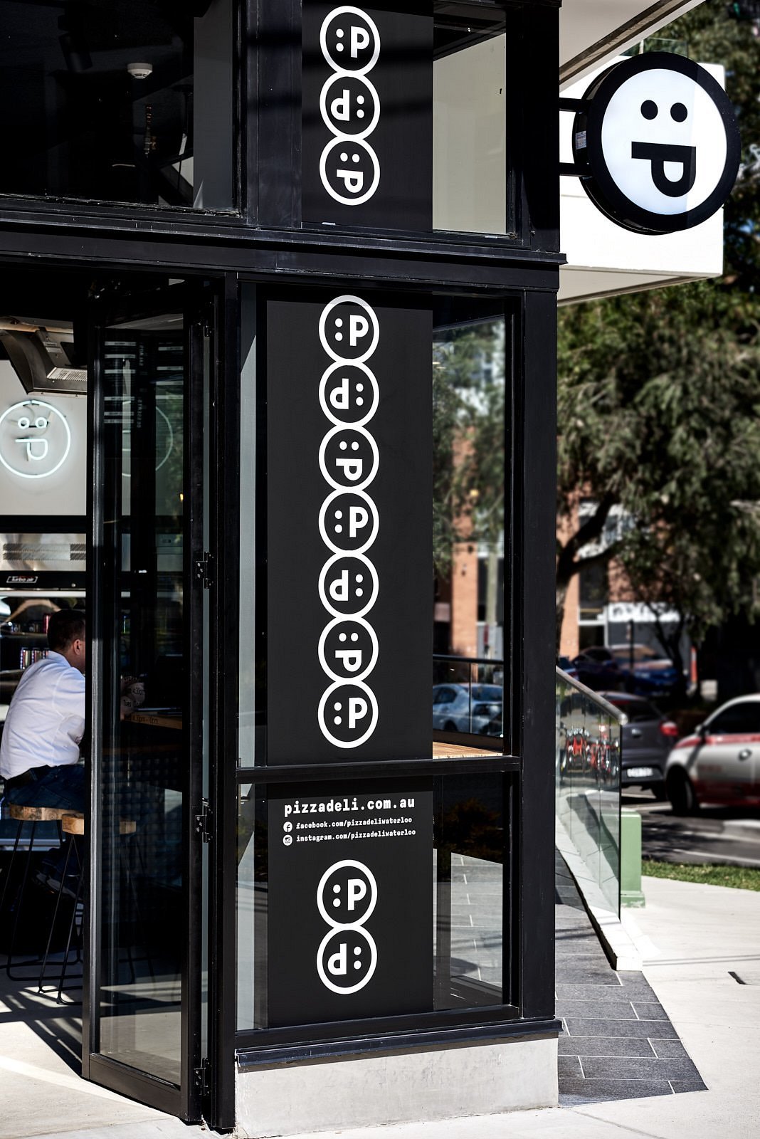 Entrance with :P branding at Pizza:deli